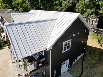 Standing seam metal roof on a two-storey home, seen from above