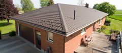 Brick house with a dark grey metal roof